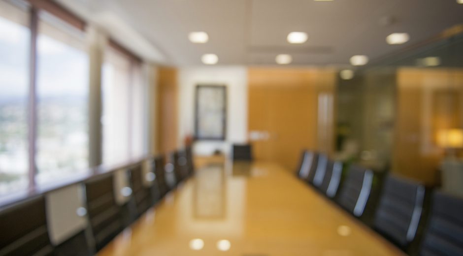 Defocused office reception area and conference room background.