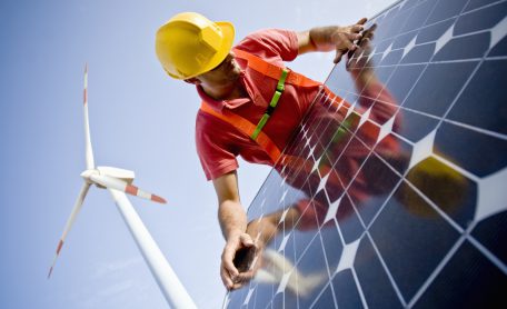 Image of a worker looking at the finishing of a solar panel. In the background you can see Wind Turbines. Two different technologies to produce energy in a responsible and sustainable way (ISO 100) . All my images have been processed in 16 Bits and transfer down to 8 before uploading.