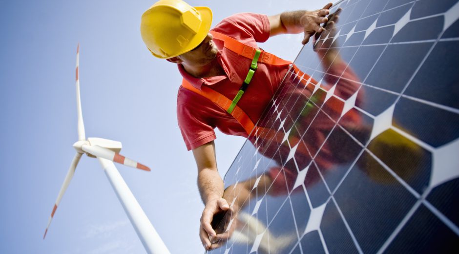 Image of a worker looking at the finishing of a solar panel. In the background you can see Wind Turbines. Two different technologies to produce energy in a responsible and sustainable way (ISO 100) . All my images have been processed in 16 Bits and transfer down to 8 before uploading.